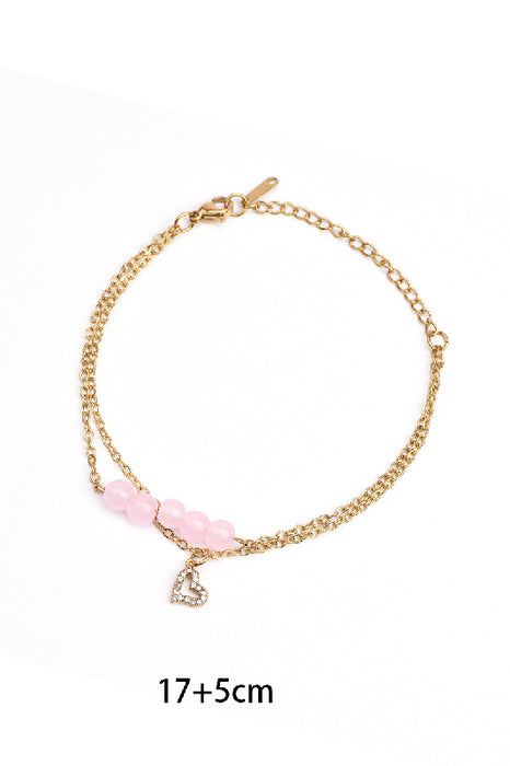Adjustable gold-plated stainless steel bracelet with pink jade and heart pendant adorned with cubic zirconia