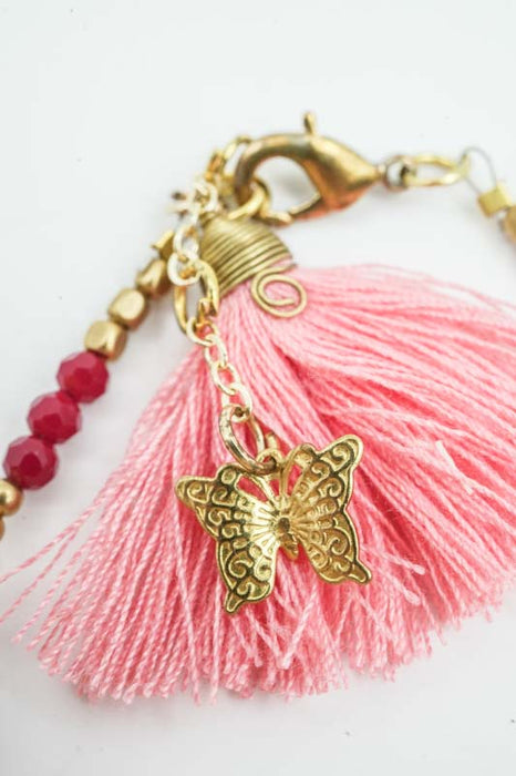 Bracelet perles de verre avec pompon abricot
